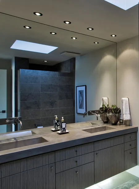A bathroom with a large mirror